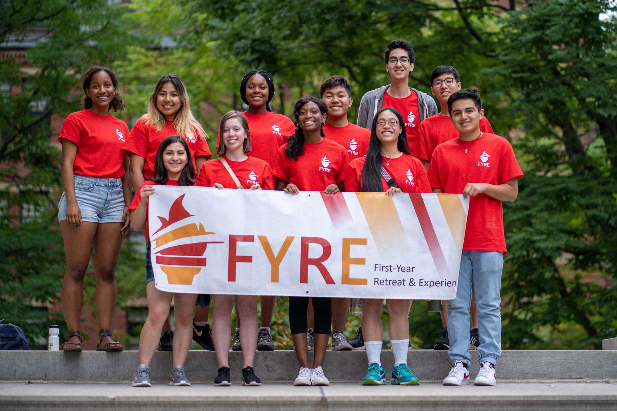 First Year Retreat and Experience - students holding banner with FYRE written on it