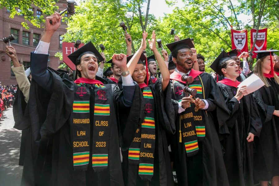 Law School graduates wave gavels. Photo: Jon Chase